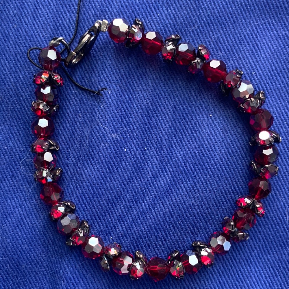 Red beaded bracelet with metal clasp.